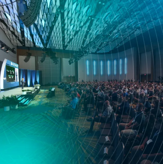 A keynote session at the Automate show, a large seated audience facing the stage