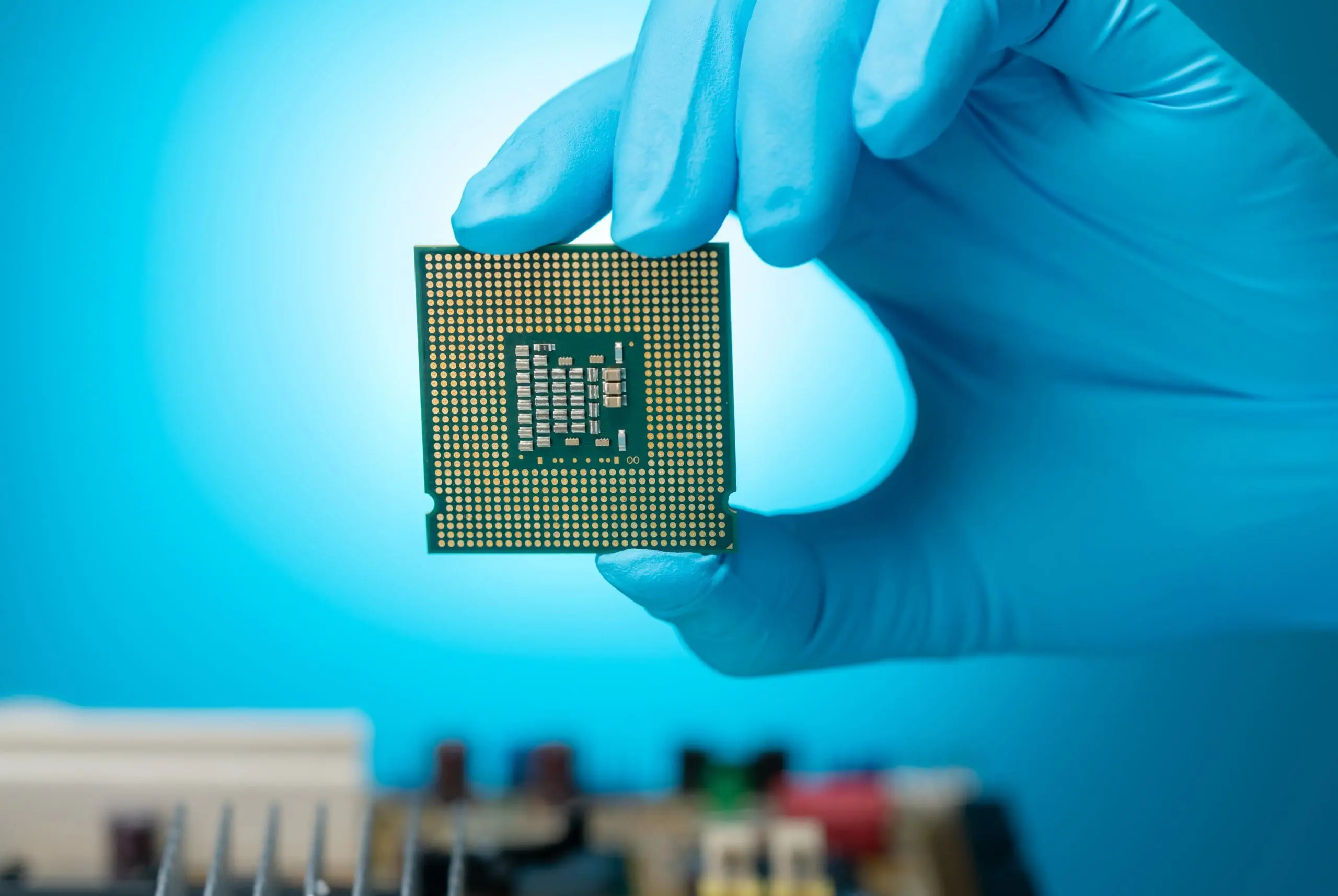 Electronics engineer inspecting a computer chip — precision LED illumination for semiconductor inspection