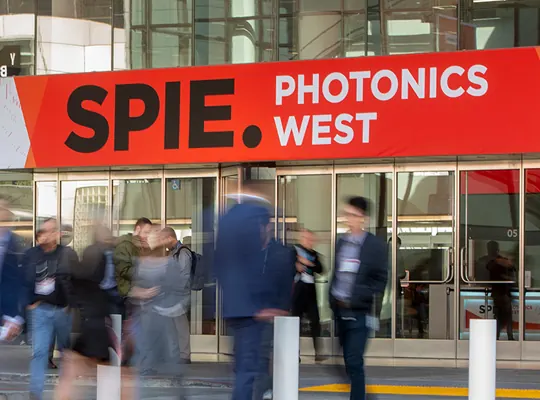 The Photonics West exhibition hall, rows of stands and visitors